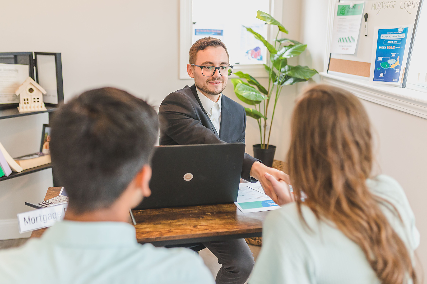 Advisor explaining account paperwork at a desk