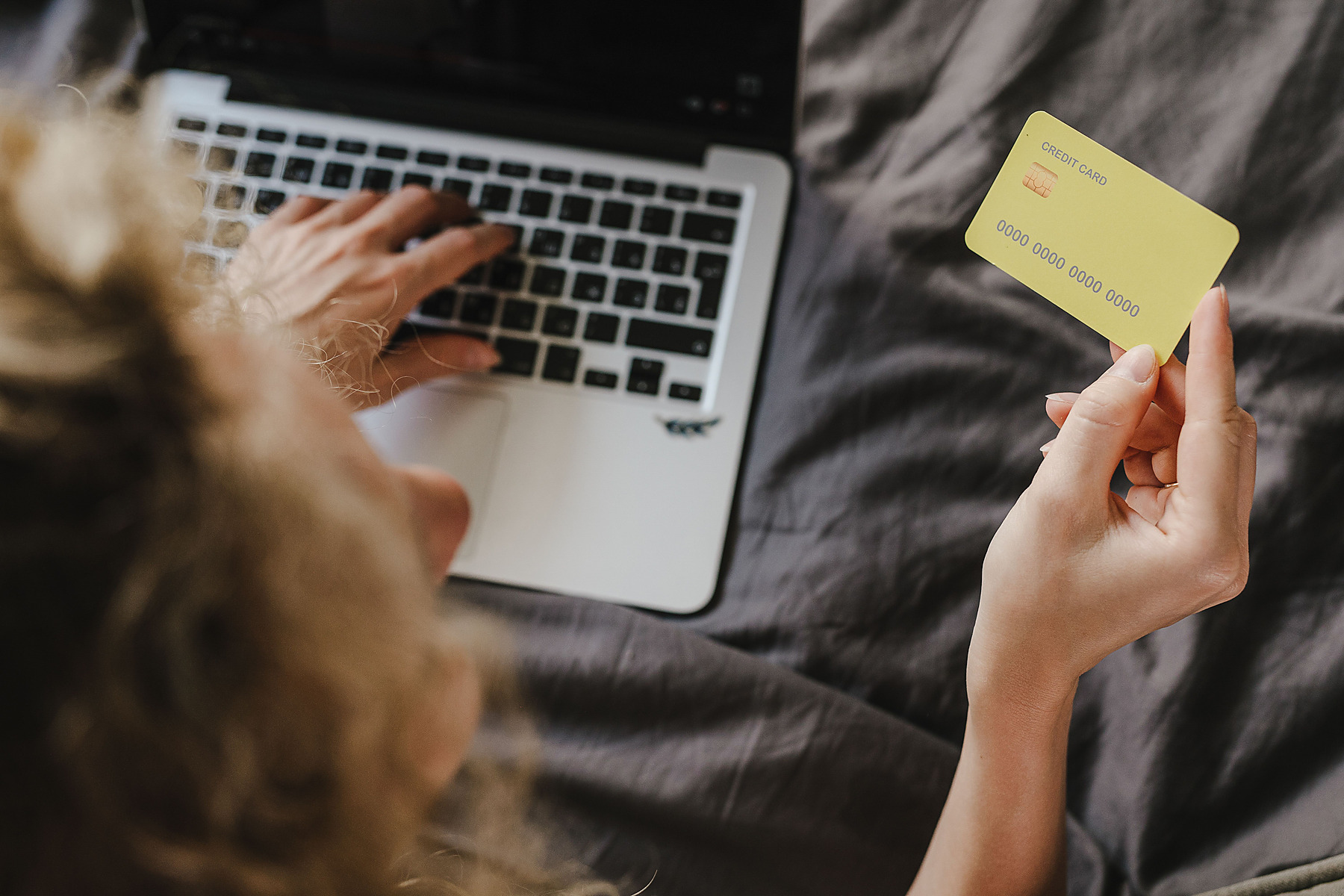 Customer using a laptop and debit card