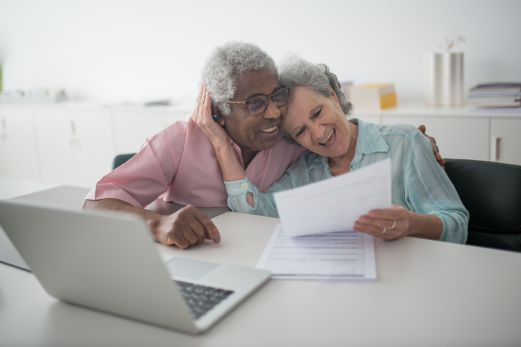 Older couple smiling during a financial planning meeting