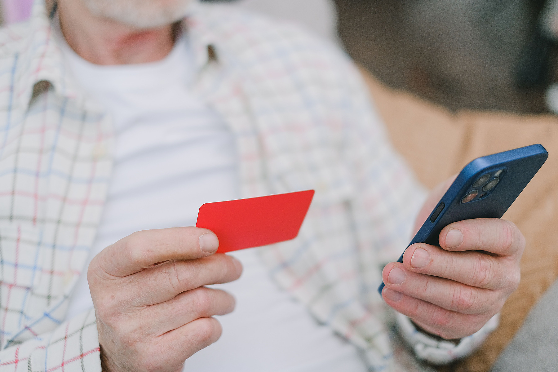 Customer holding a bank card and mobile phone