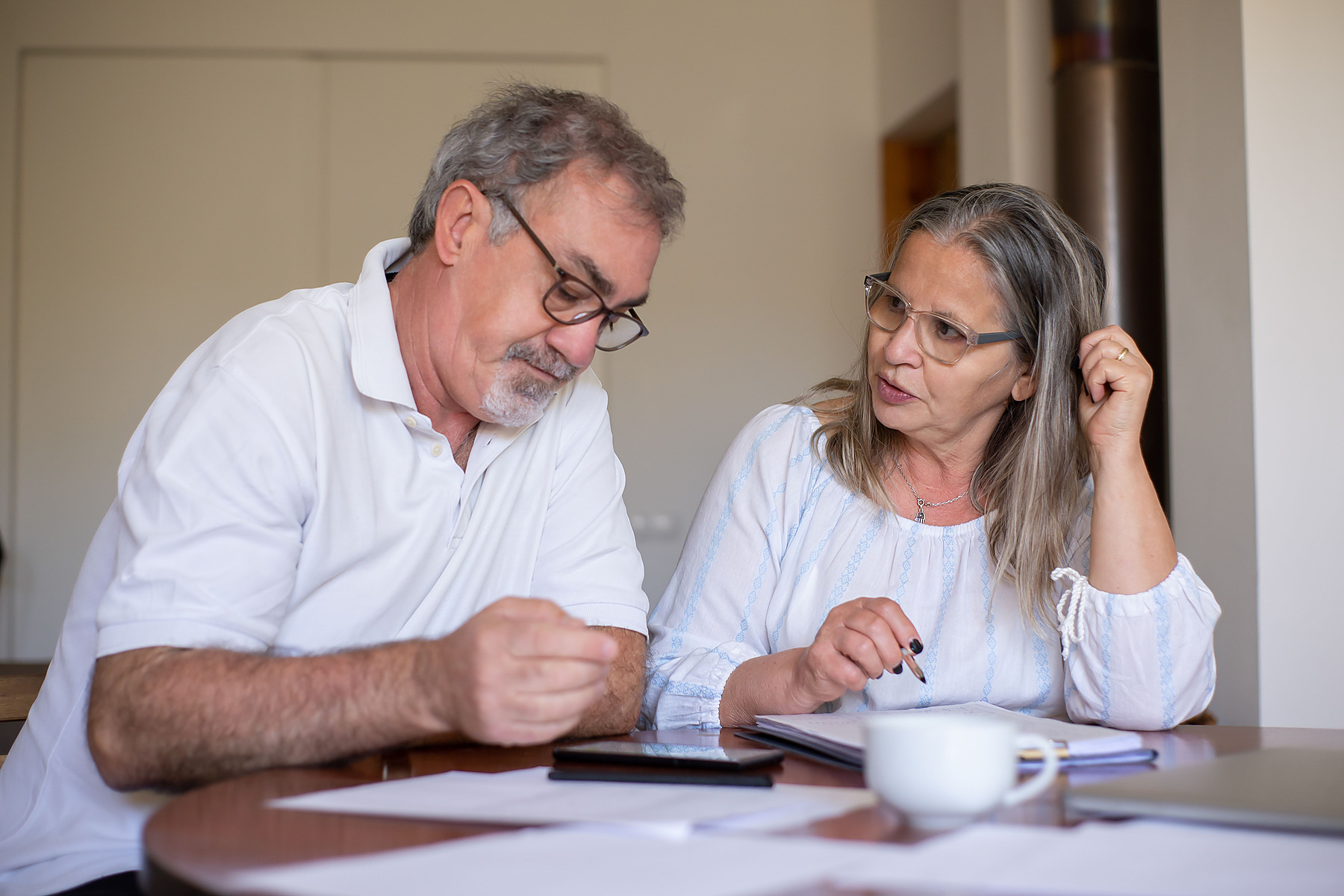 Older customers signing account documents with an advisor